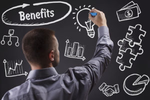 Technology internet business and marketing. Young business man writing word: Benefits